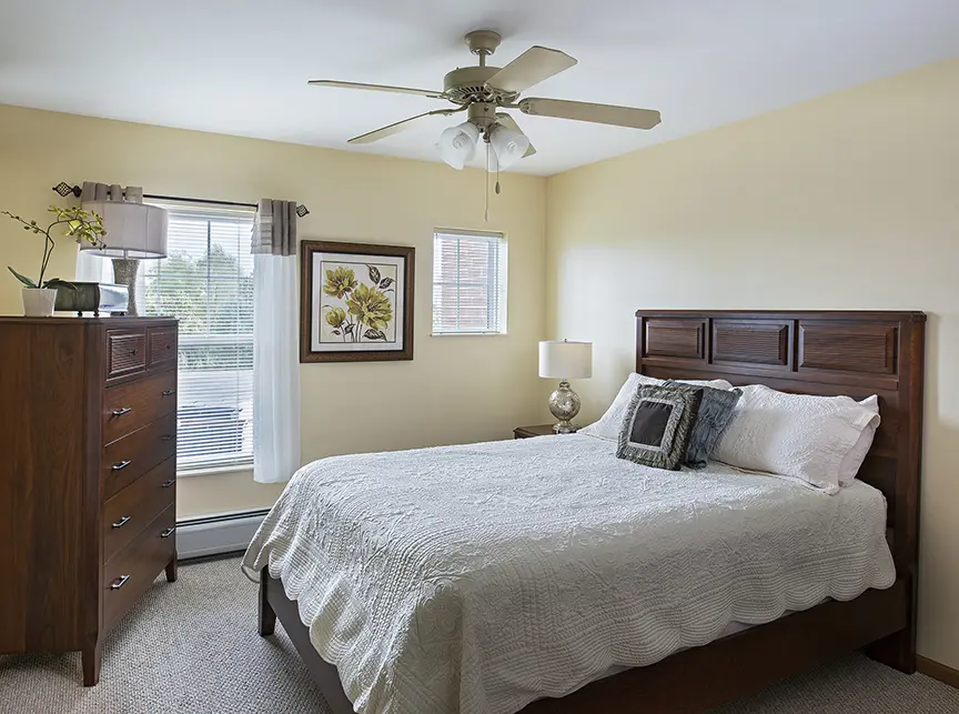 Bedroom of a senior apartment at American House Cedarlake, a senior living community in Plainfield, Illinois