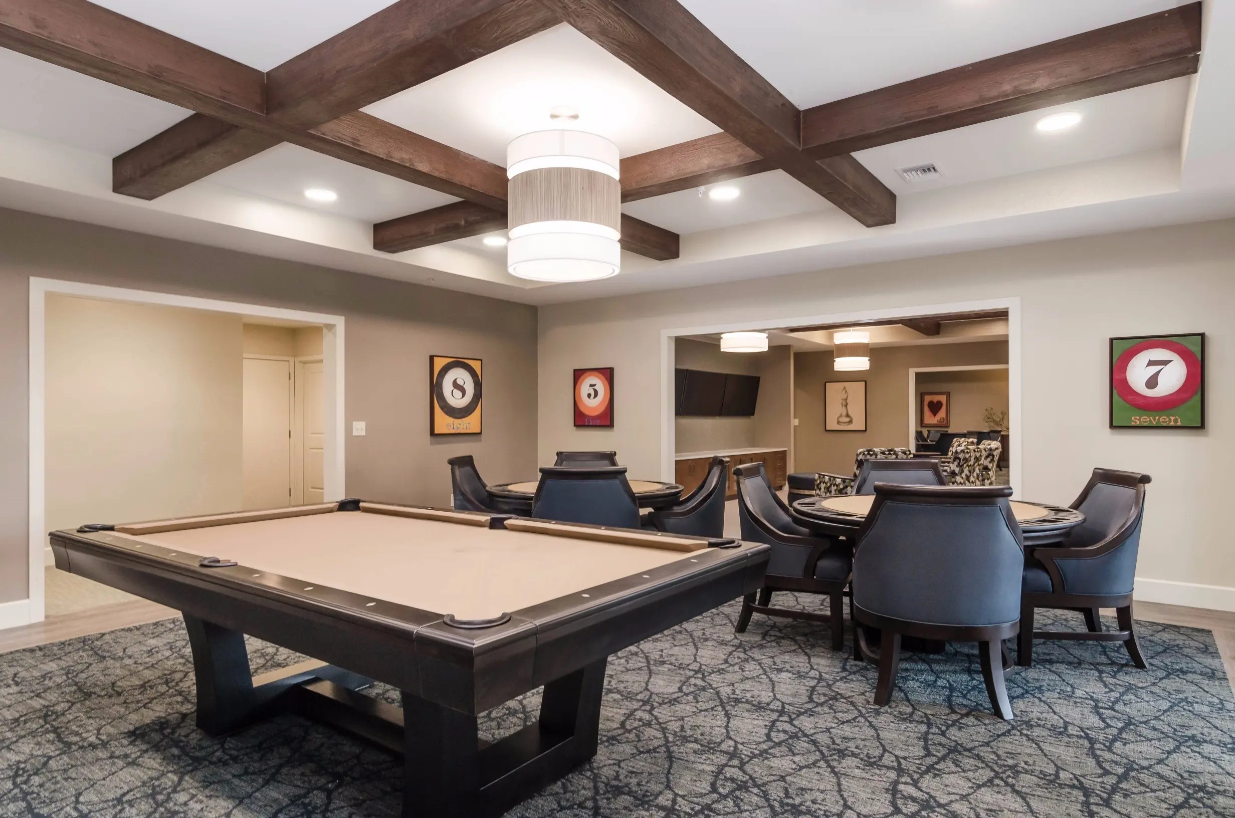 Game / common area at American House Coconut Point, a senior living community in Estero, FL