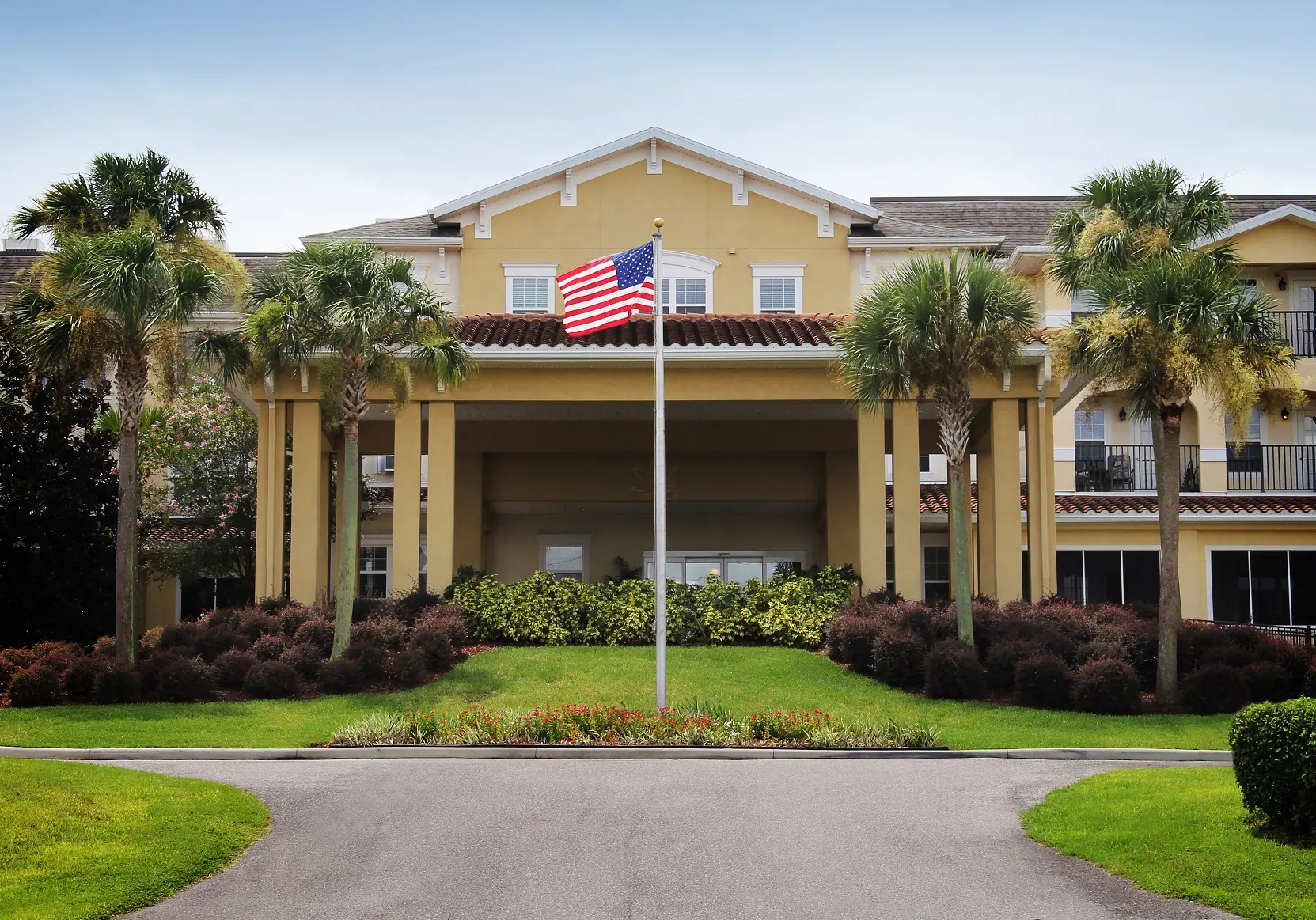 Front entrance to retirement home in Zephyrhills, Florida with USA flag in foreground.