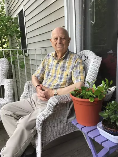 Pastor sitting in chair on porch