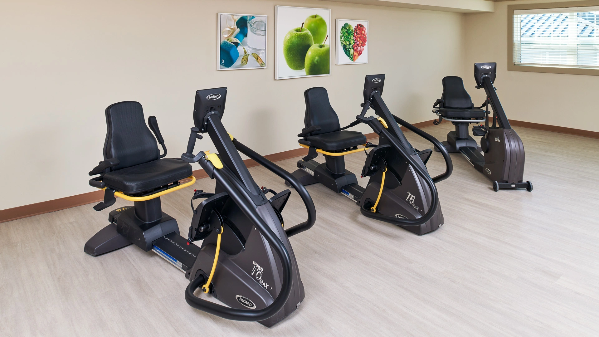 An exercise room with three recumbent bikes at a senior living community in Bloomfield Hills, MI