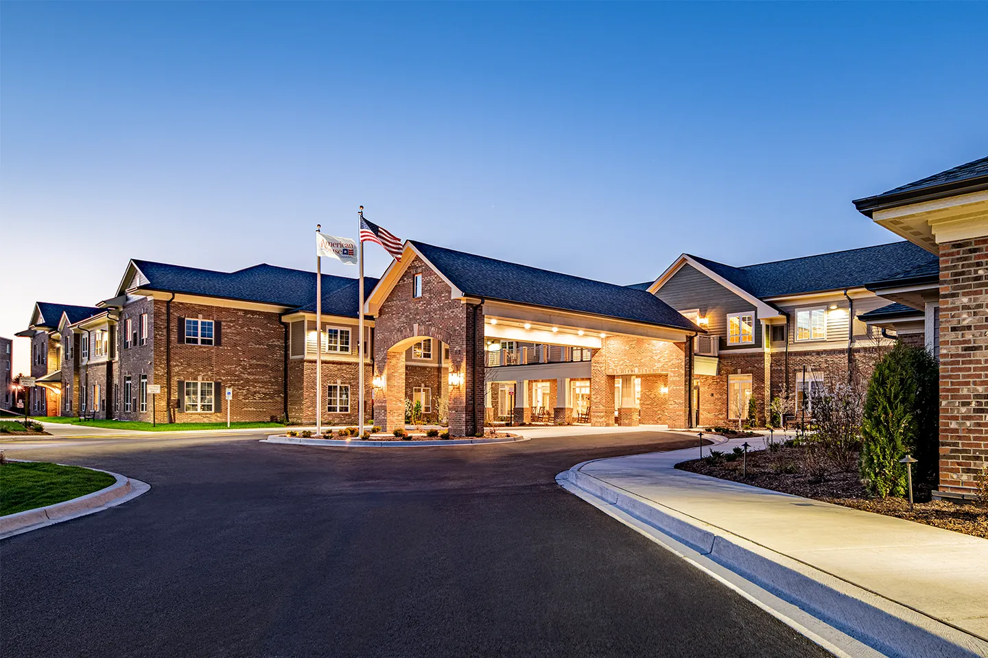 Exterior of American House Mount Prospect senior living at dusk