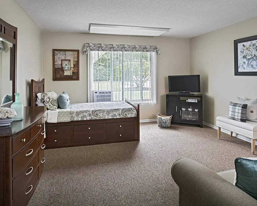 Bedroom of a senior apartment at American House Livonia, a senior living community in Livonia, Michigan