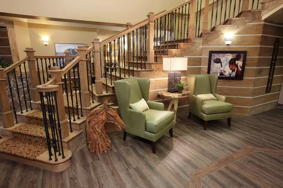 Staircase and seating area in American House independent living community in Wildwood, FL