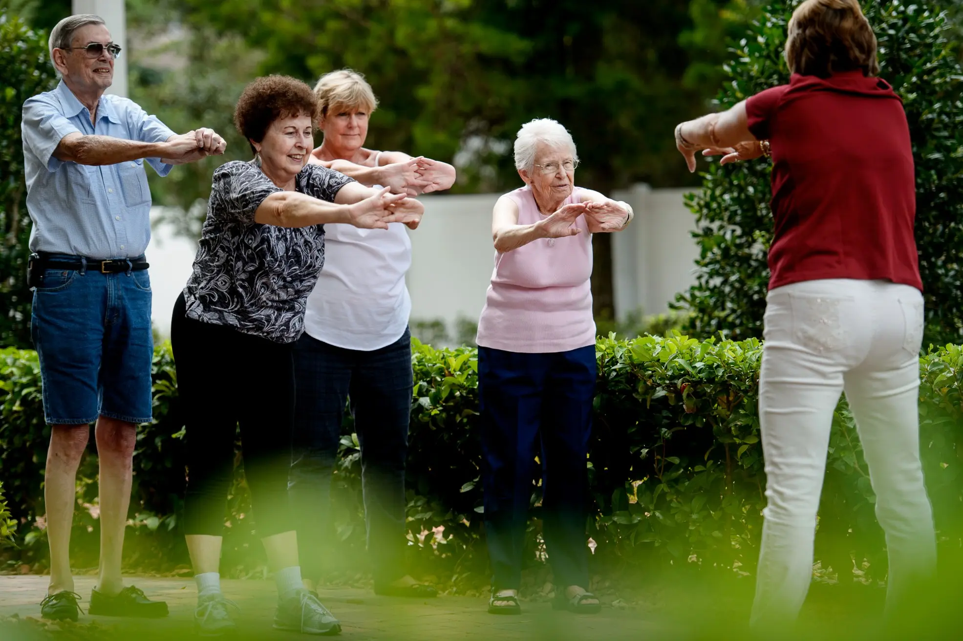 Seniors exercising outside of a senior living community in Niceville, FL
