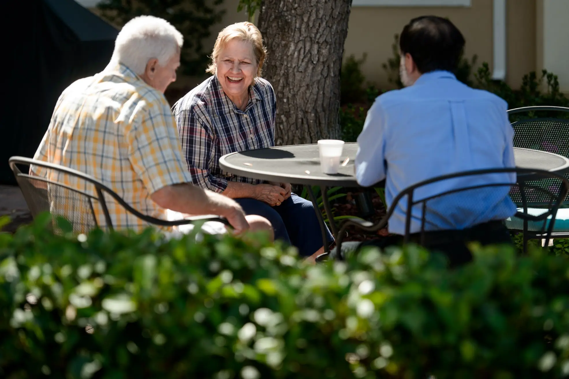 Seniors sitting in a courtyard outside of a senior living community in Niceville, FL
