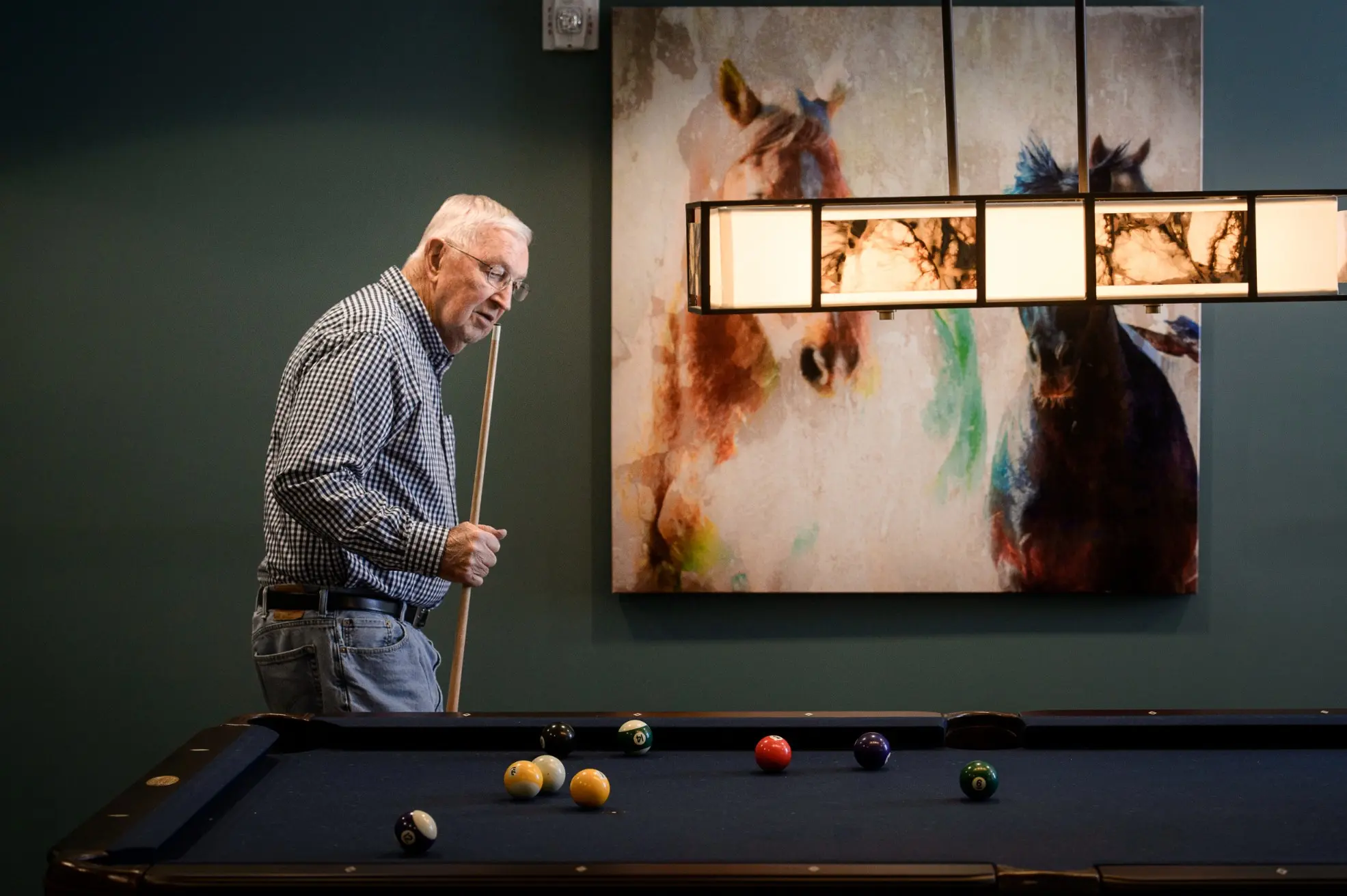 Senior playing billiards in the activity room of a senior living community in Niceville, FL