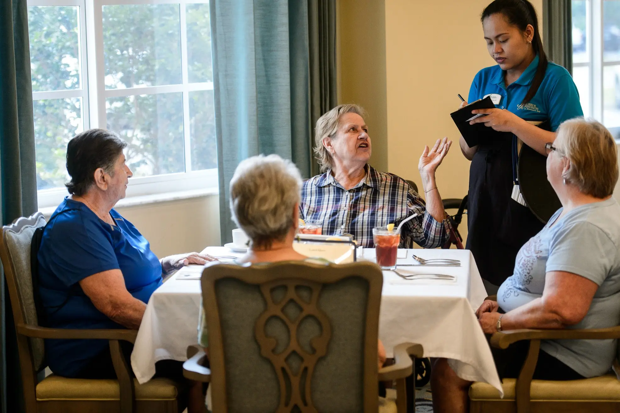 Seniors sitting at the dining area of a retirement community in Niceville, FL