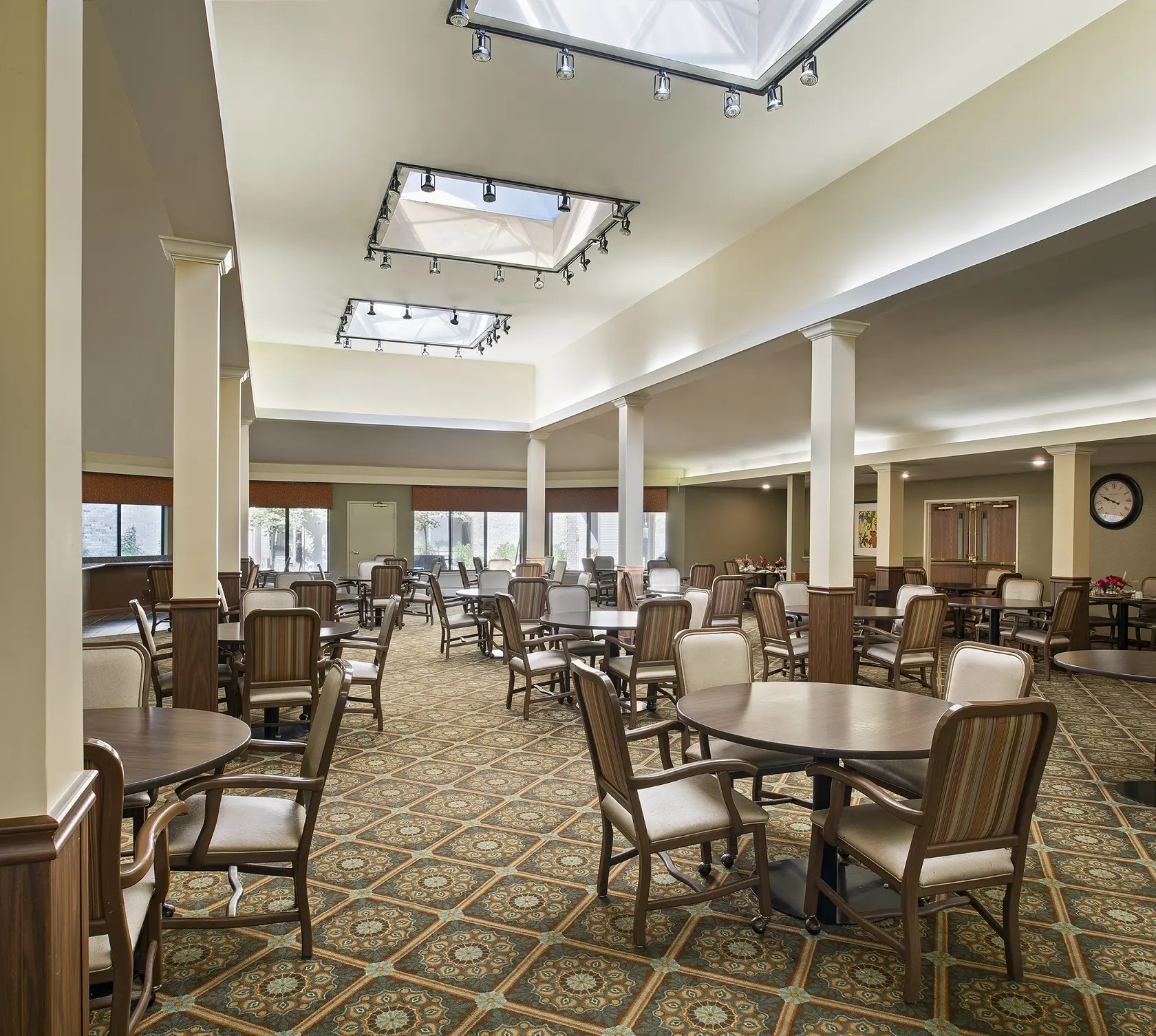 Large carpeted dining area of American House Carpenter, a senior living community in Ypsilanti, Michigan
