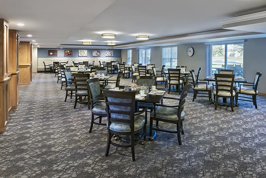 Carpeted dining hall at American House Cedarlake, a senior living community in Plainfield, Illinois