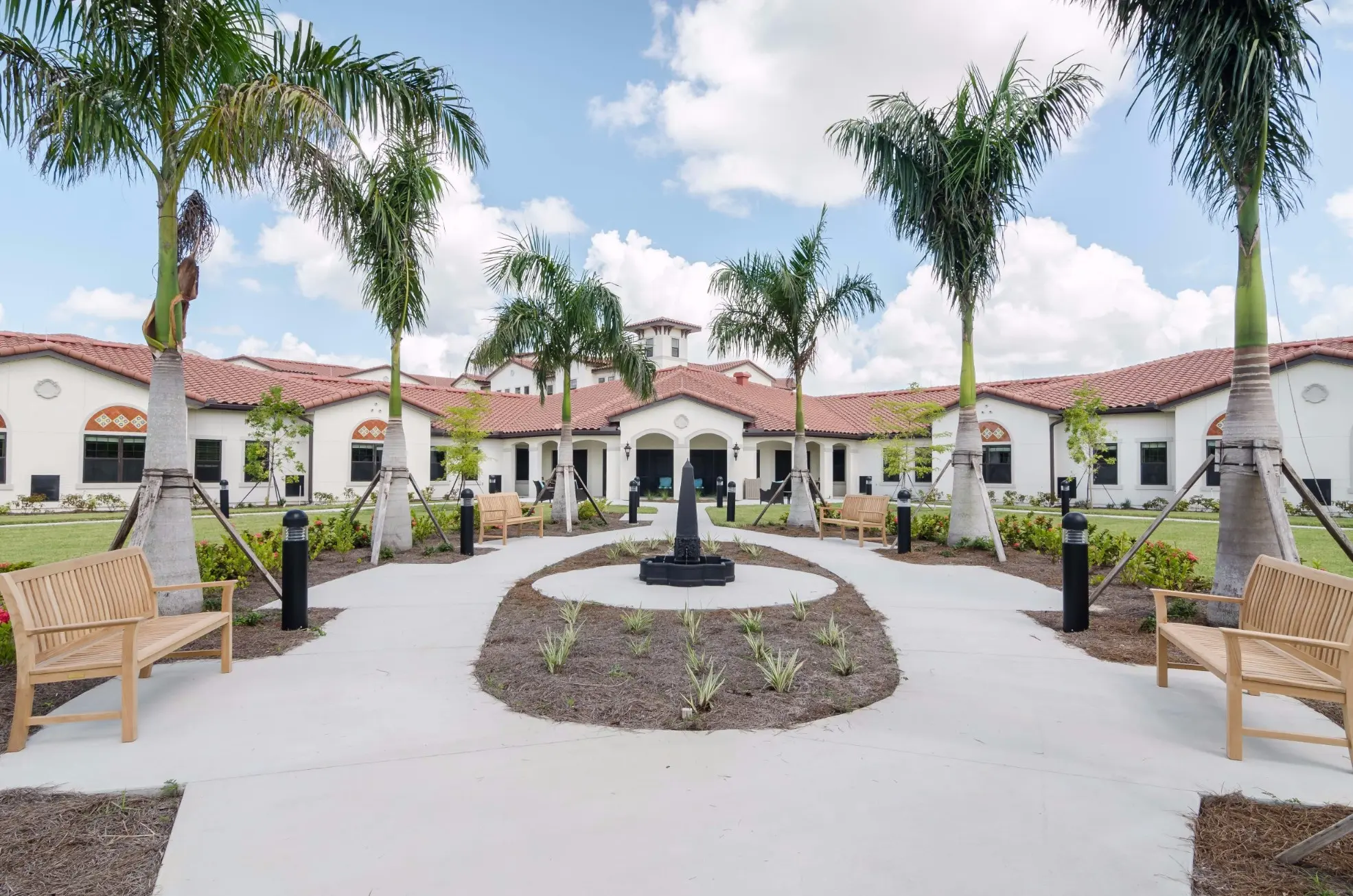 Exterior shot / entrance of American House Coconut Point, a senior living community in Estero, FL