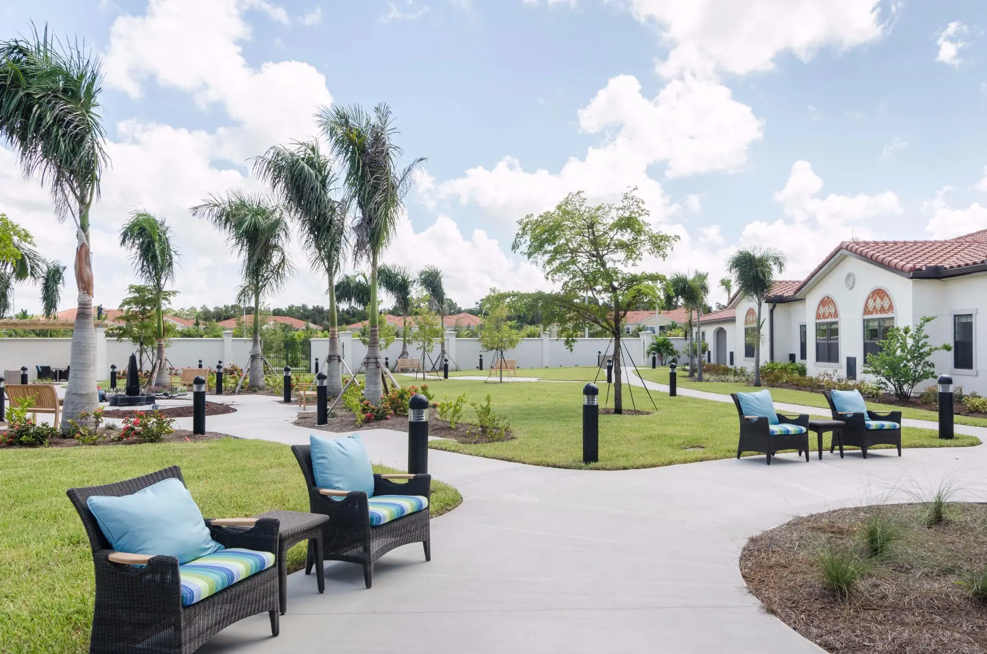 Exterior shot / courtyard of American House Coconut Point, a senior living community in Estero, FL