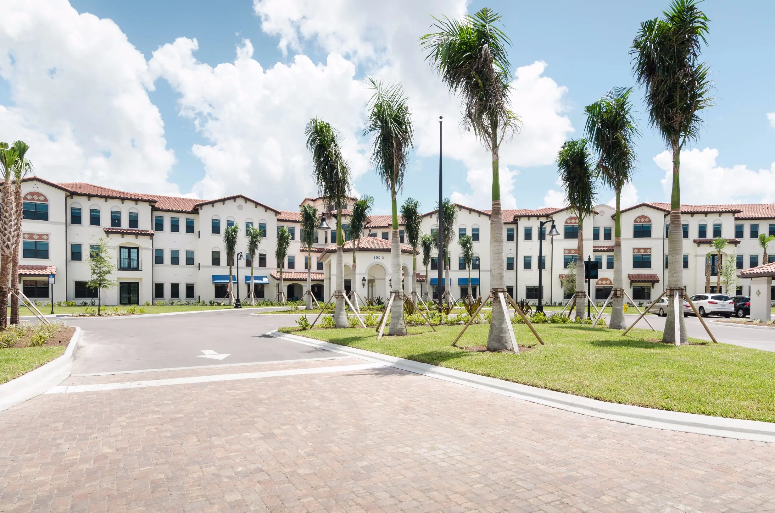 Exterior shot / driveway of American House Coconut Point, a retirement community in Estero, FL