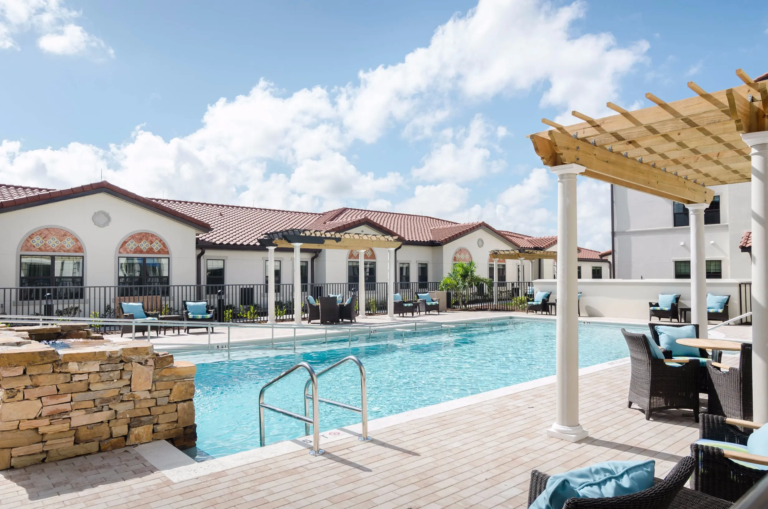 Exterior shot / pool of American House Coconut Point, a retirement community in Estero, FL