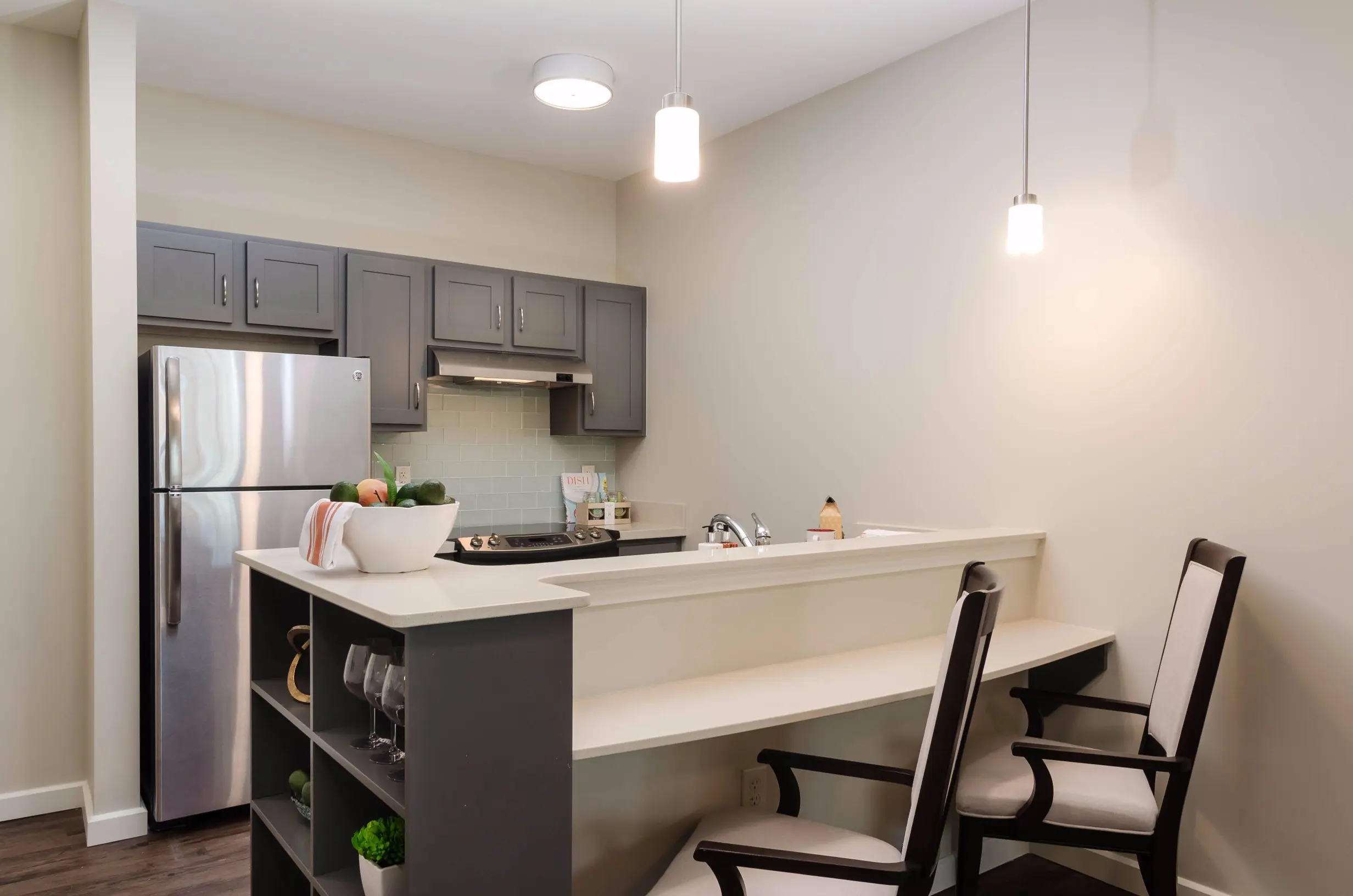 Kitchenette of a senior apartment at American House Coconut Point, a senior living community in Estero, FL