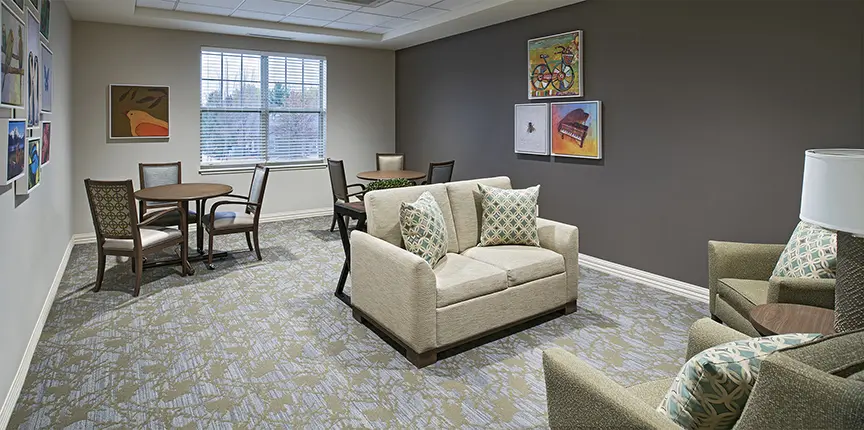 Carpeted common area of American House Freedom Place Rochester, a memory care community in Rochester, Michigan adsf