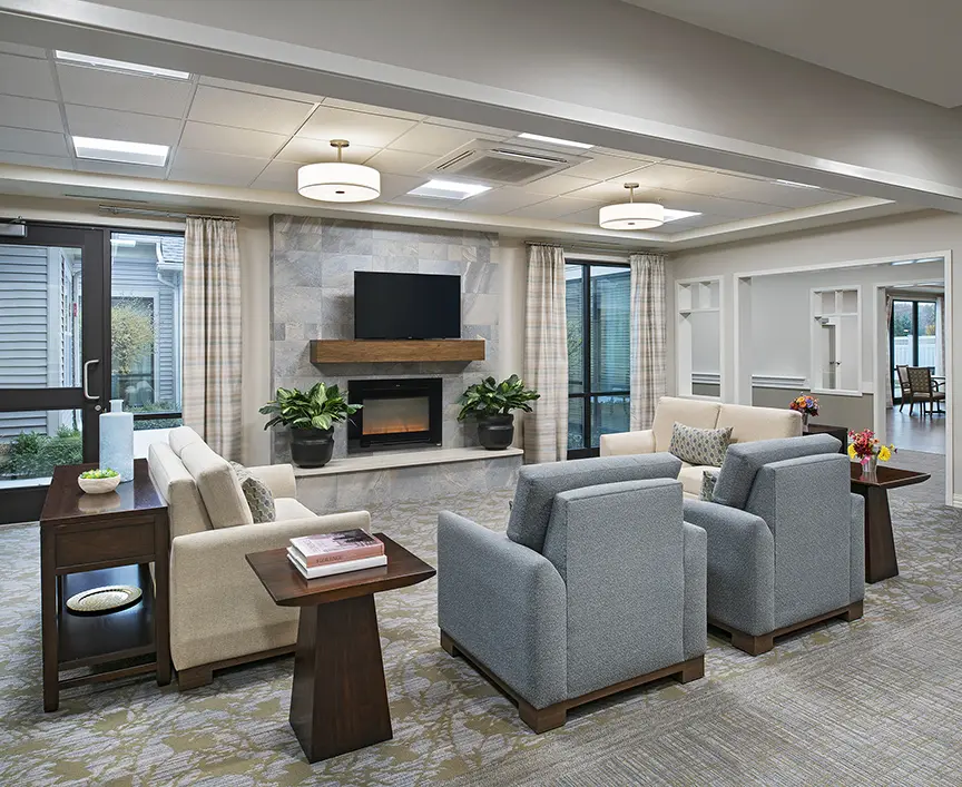 Carpeted lobby area of American House Freedom Place Rochester, a memory care community in Rochester, Michigan