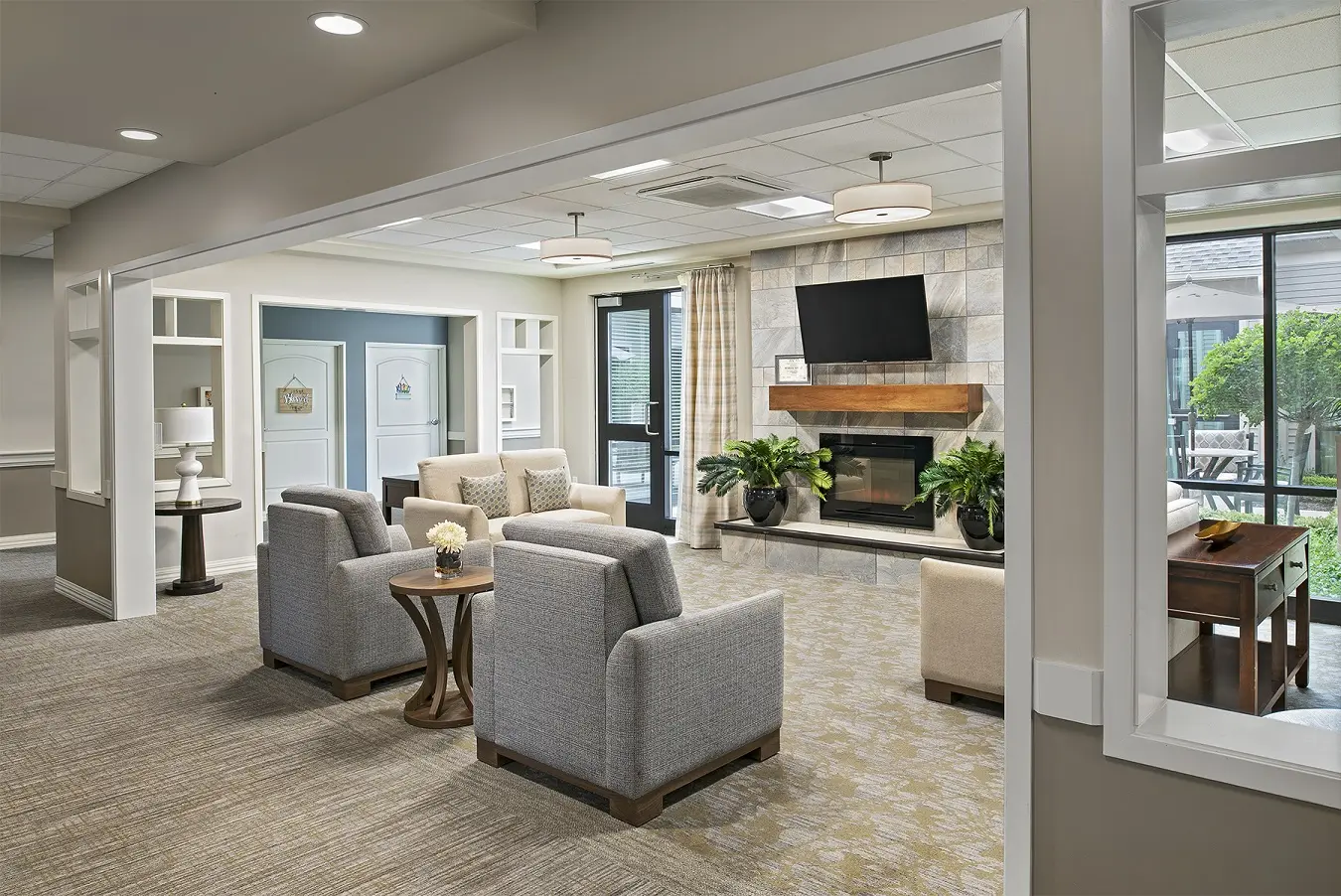 Carpeted lobby area at American House Freedom Place Roseville, a memory care community in Roseville, Michigan