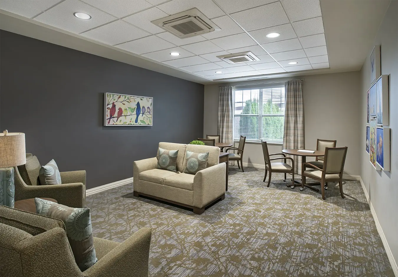 Carpeted common area at American House Freedom Place Roseville, a memory care community in Roseville, Michigan