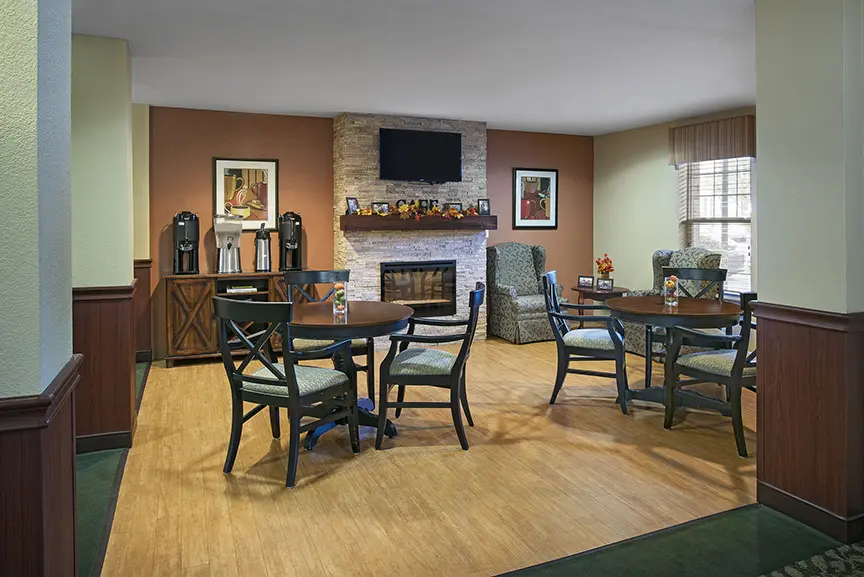 Common area with fireplace at American House Milford, a retirement community in Milford, Michigan