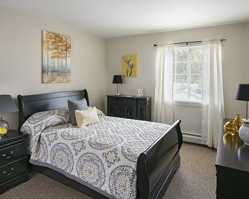 Senior apartment bedroom at American House Southgate, a senior home in Southgate, MI