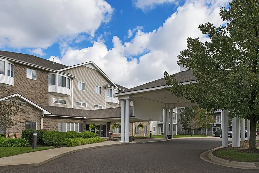 Front exterior and car port at American House retirement home, in Taylor, MI