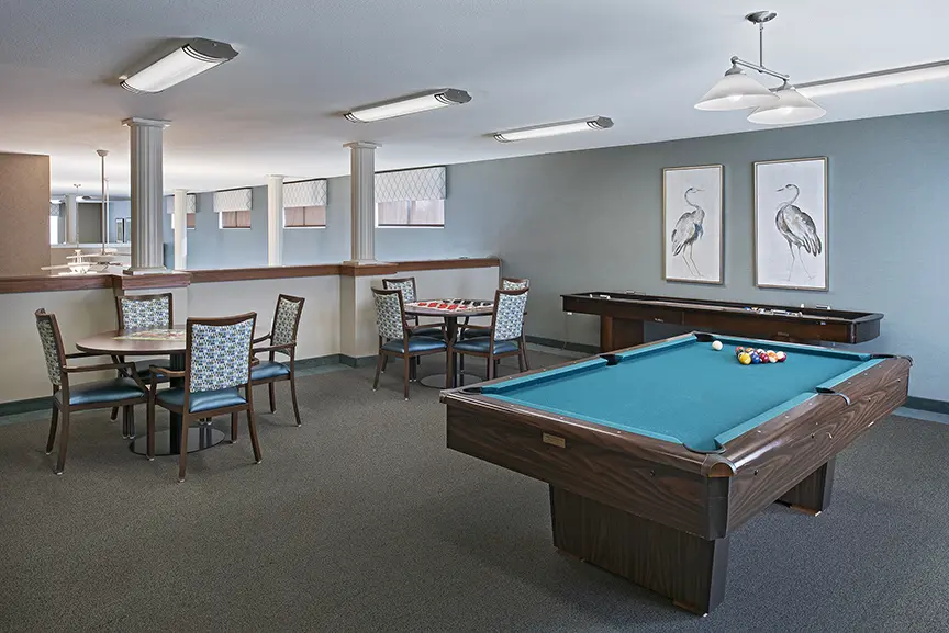 Game room with billiard table at American House Senior Living, in Taylor, MI.