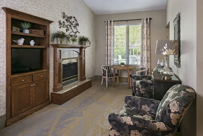 Sitting room with fireplace at American House assisted living campus in Spring Lake, MI