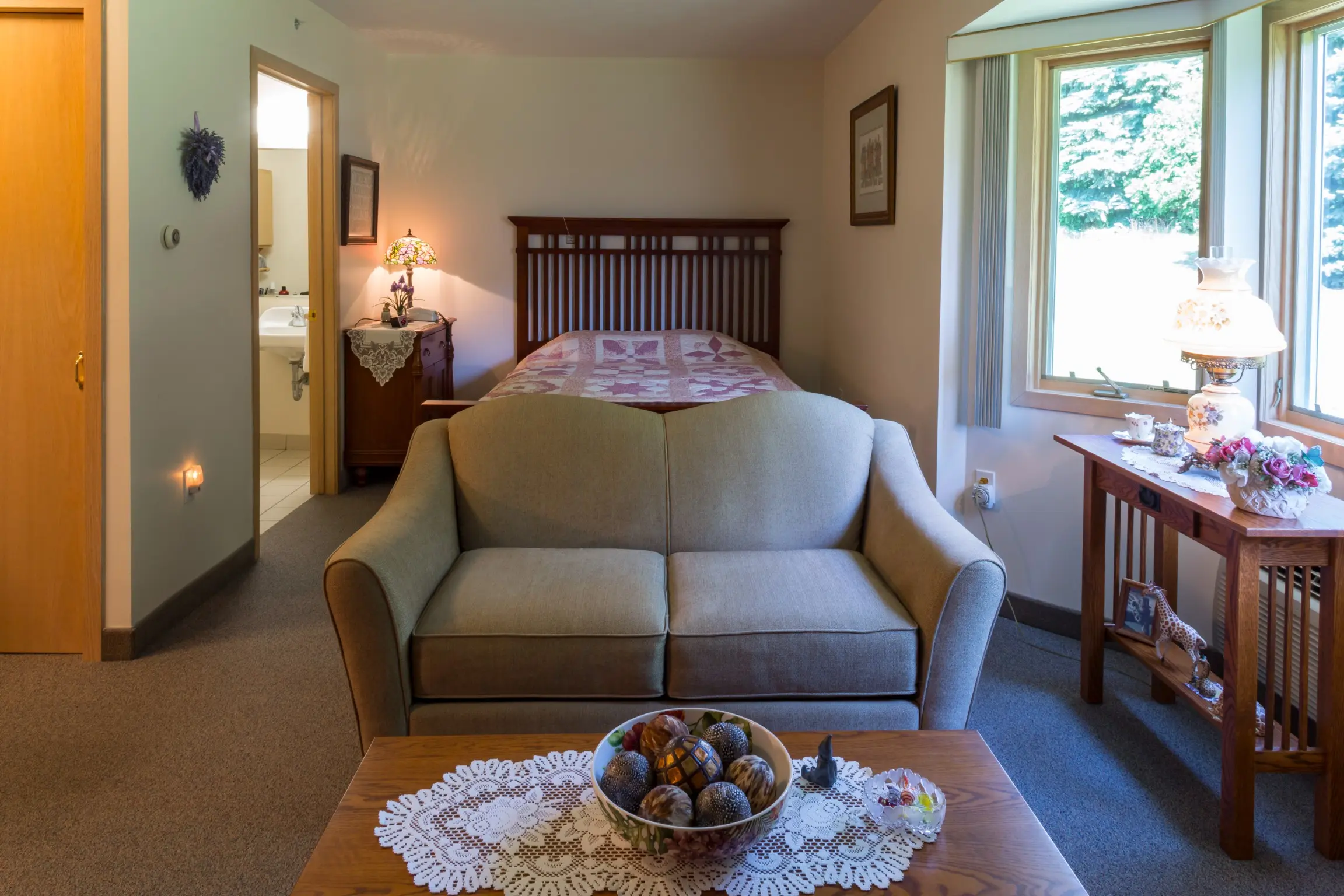 Bedroom and couch at American House memory care unit in Spring Lake, MI