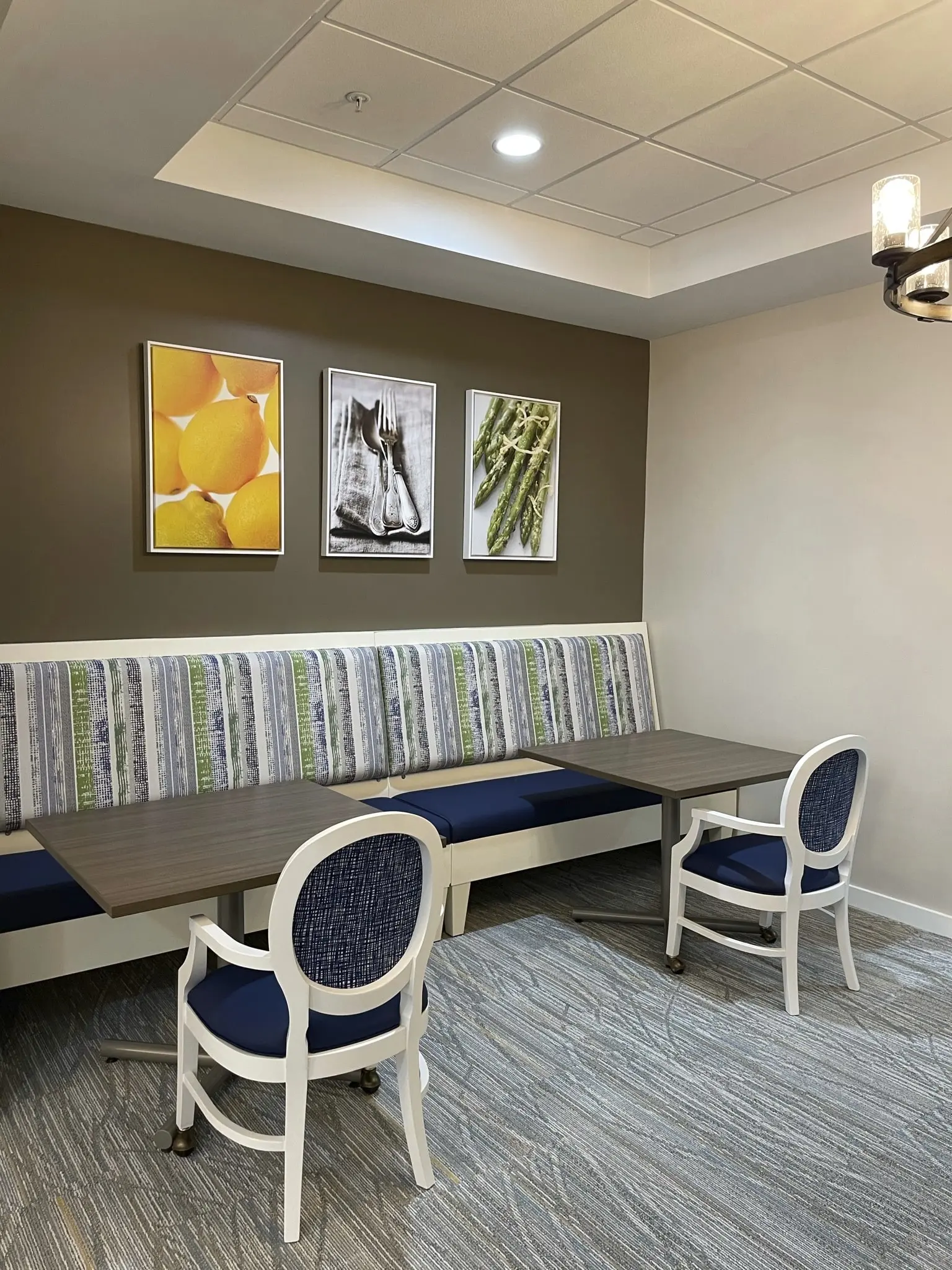 Dining tables and paintings of food at American House senior community in St. Petersburg, FL