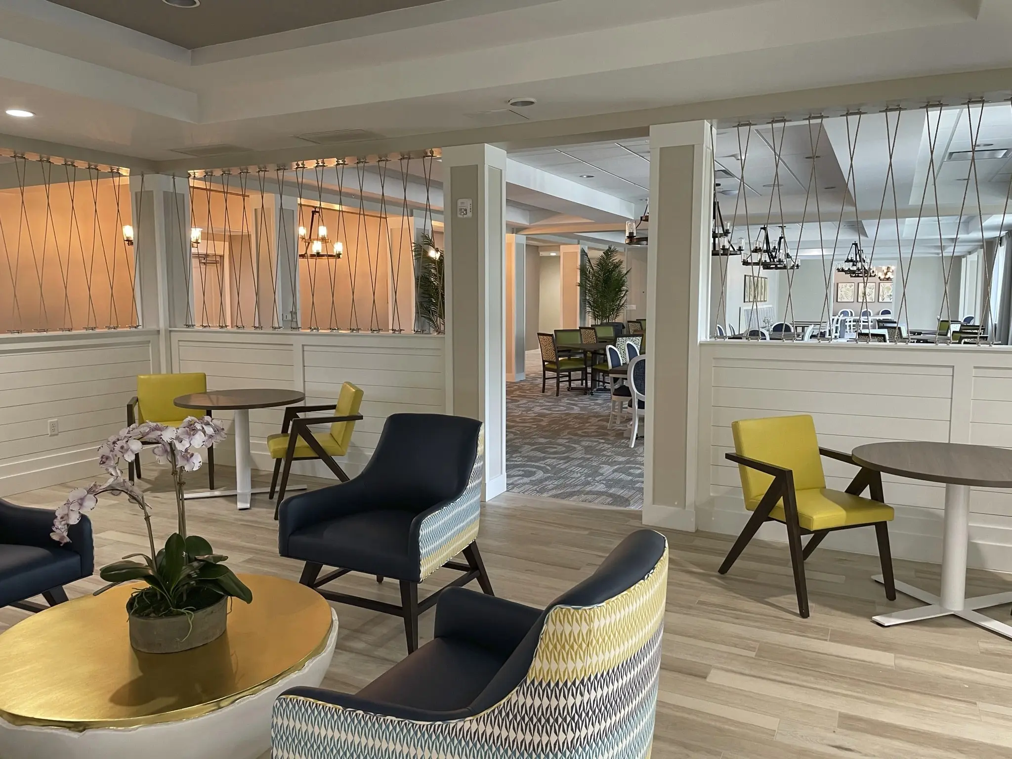 Tables and chairs in dining area at senior home in St. Petersburg, FL