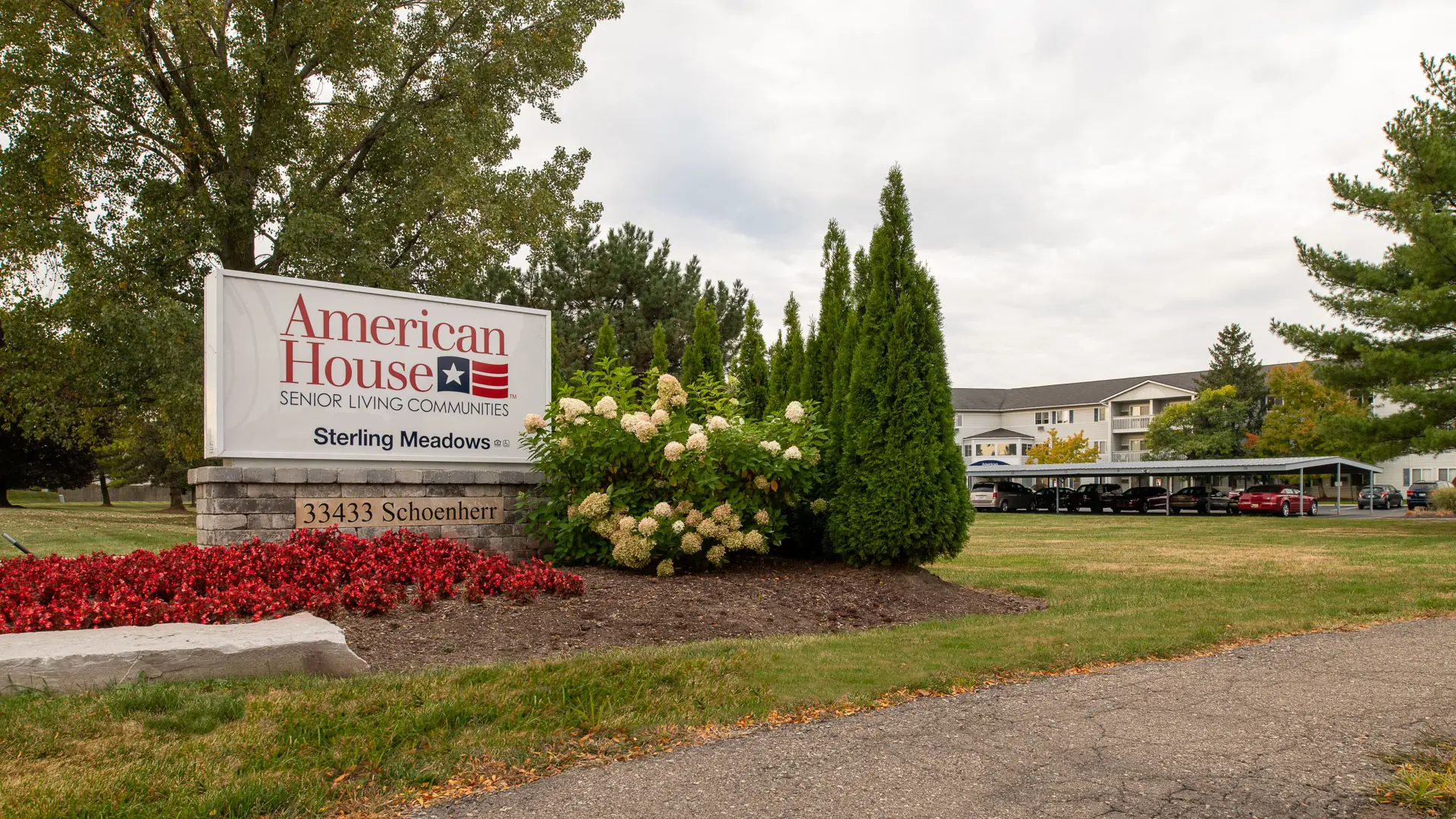 Front driveway and sign with American House logo and address 33433 Schoenherr