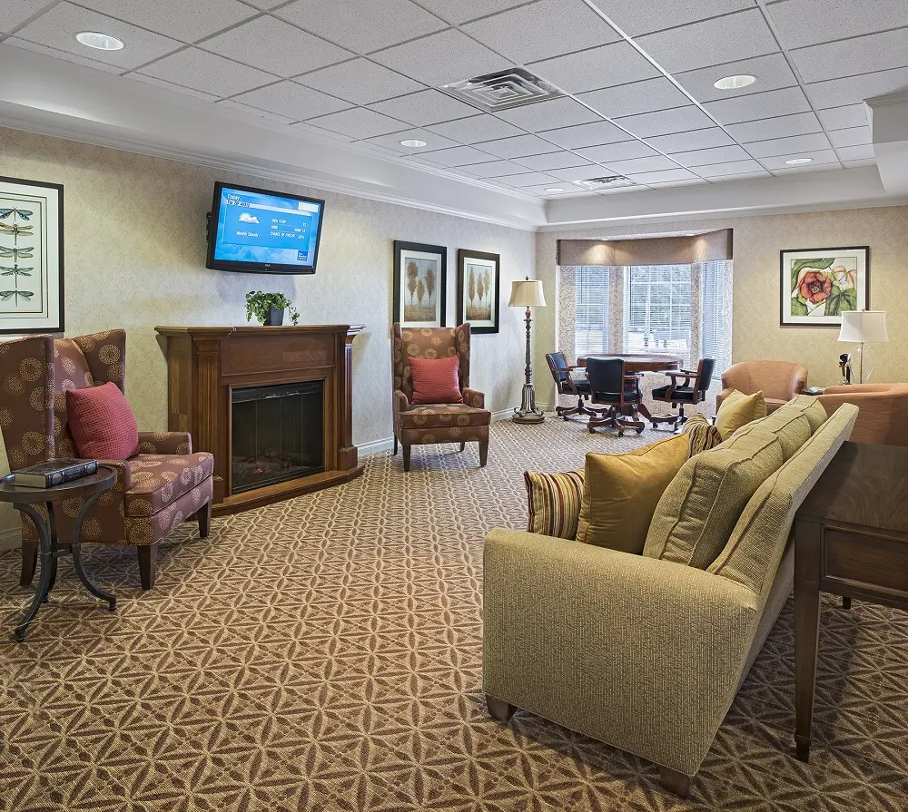 Common area with TV and fireplace at American House senior retirement home in North Sterling Heights, MI