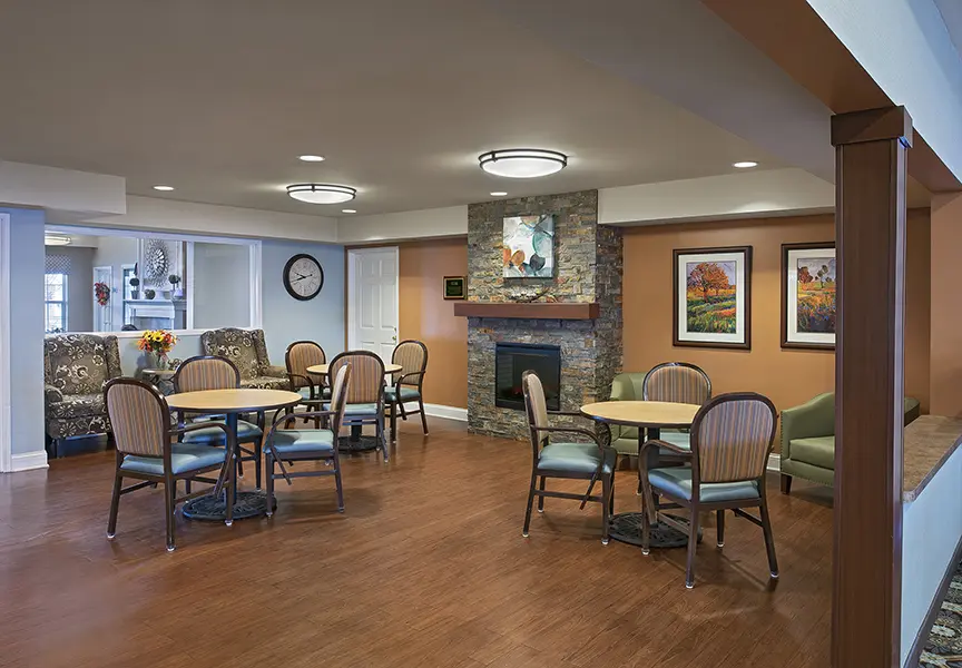 Common area with fireplace American House elder care in Tory, MI