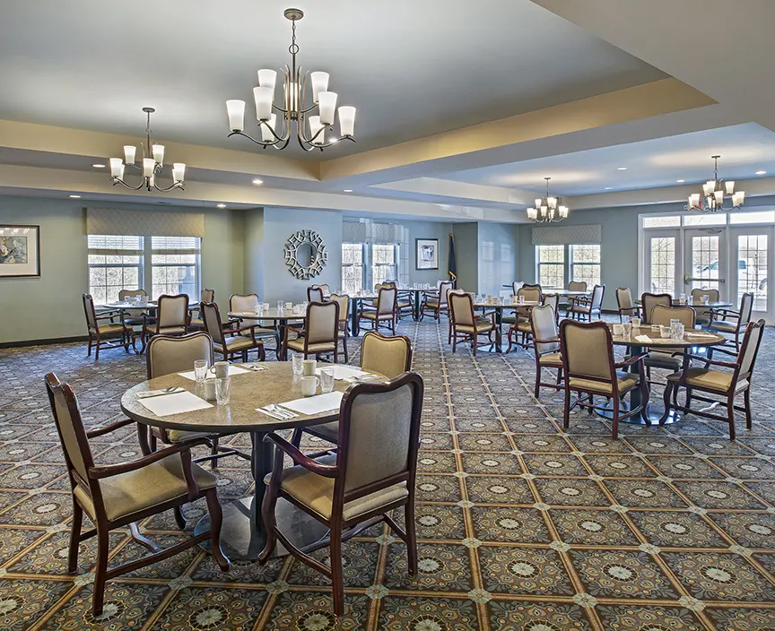 Dining area with high ceilings and chandeliers at retirement community in Troy, MI