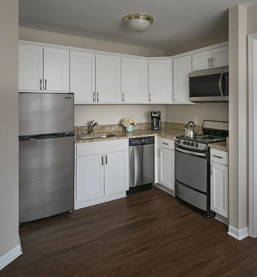 Modern kitchen for seniors with stainless steel appliances and granite counter tops.