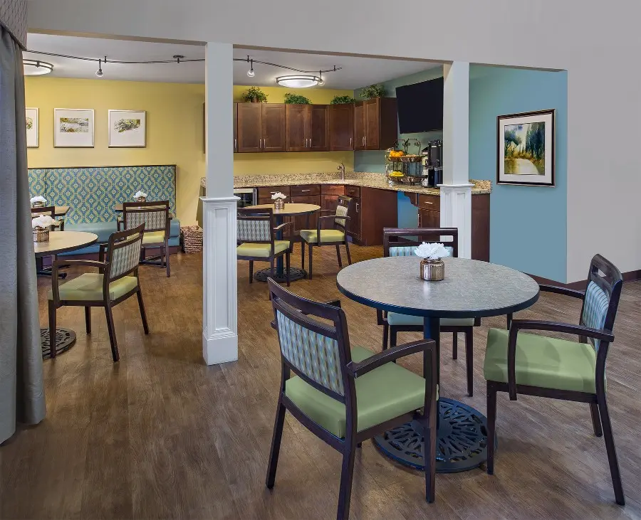 A bistro for senior citizens with green chairs and granite counter tops in West Bloomfield, MI.