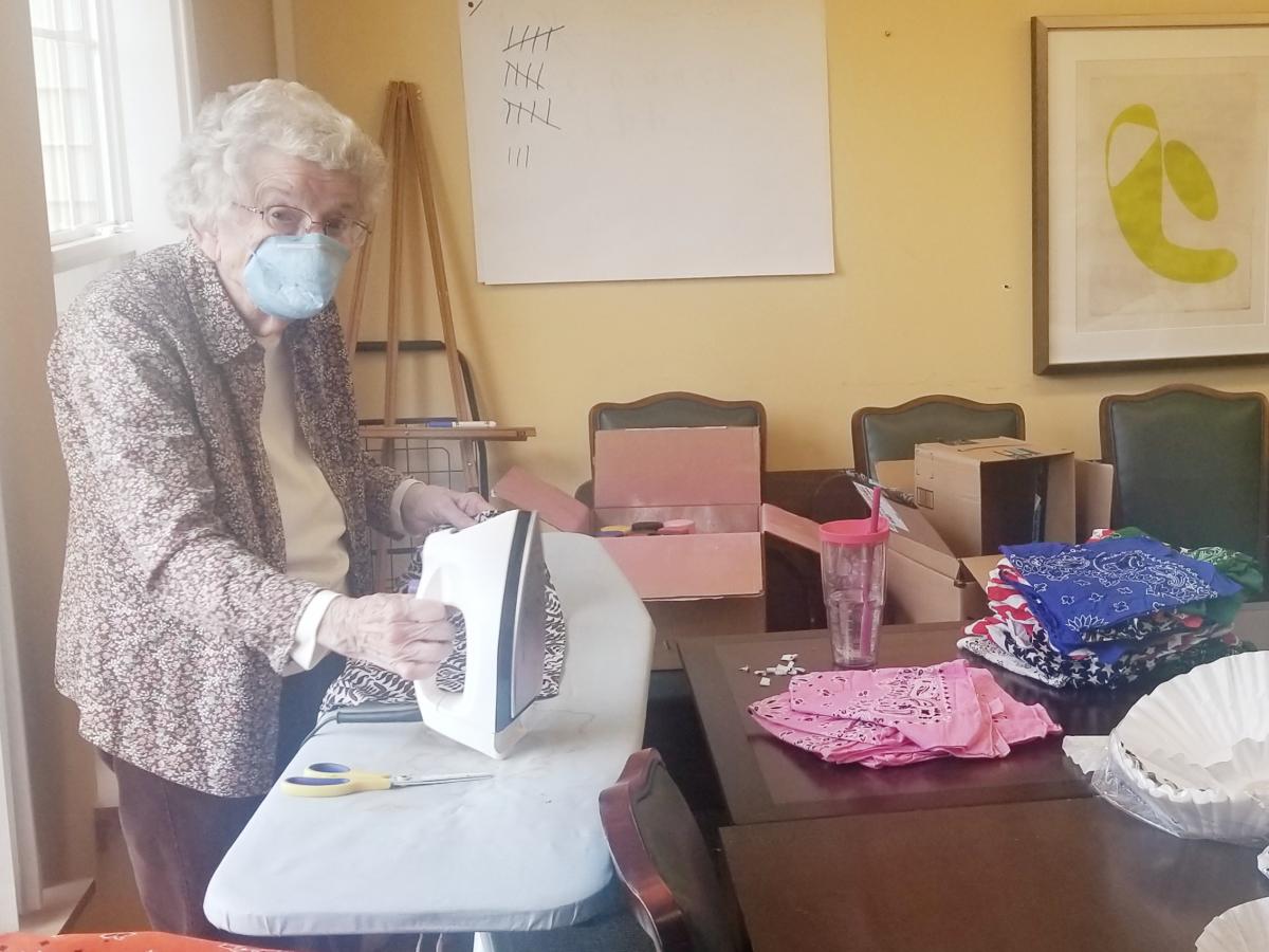 Woman ironing a mask